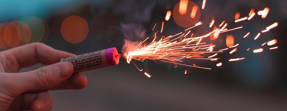 Hand Holding Lit Firework